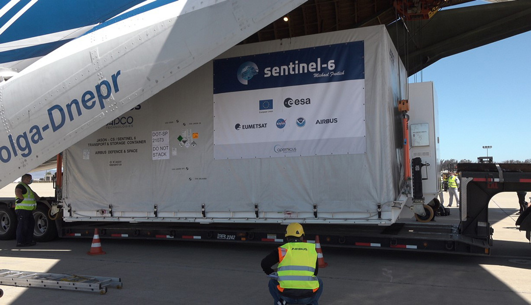 A shipping container containing the Sentinel-6 Michael Freilich satellite is removed from an Antonov 124 aircraft at Vandenberg Air Force Base in California