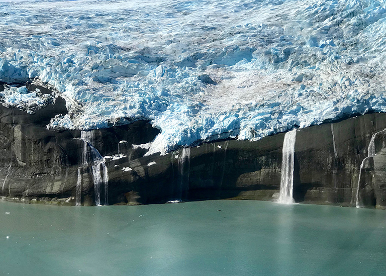 Melt water cascades from beneath a glacier into Icy Bay, Alaska, as seen from an Operation Ice Bridge flight. Credit: NASA/Maria-José Viñas