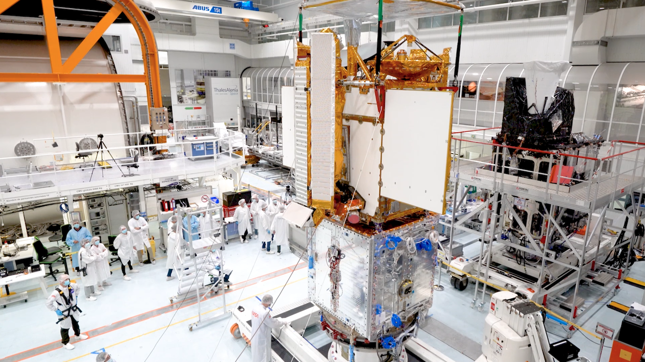 Engineers integrate separate parts of the SWOT satellite into one in a clean room facility in Cannes, France. Image Credit: Thales Alenia Space